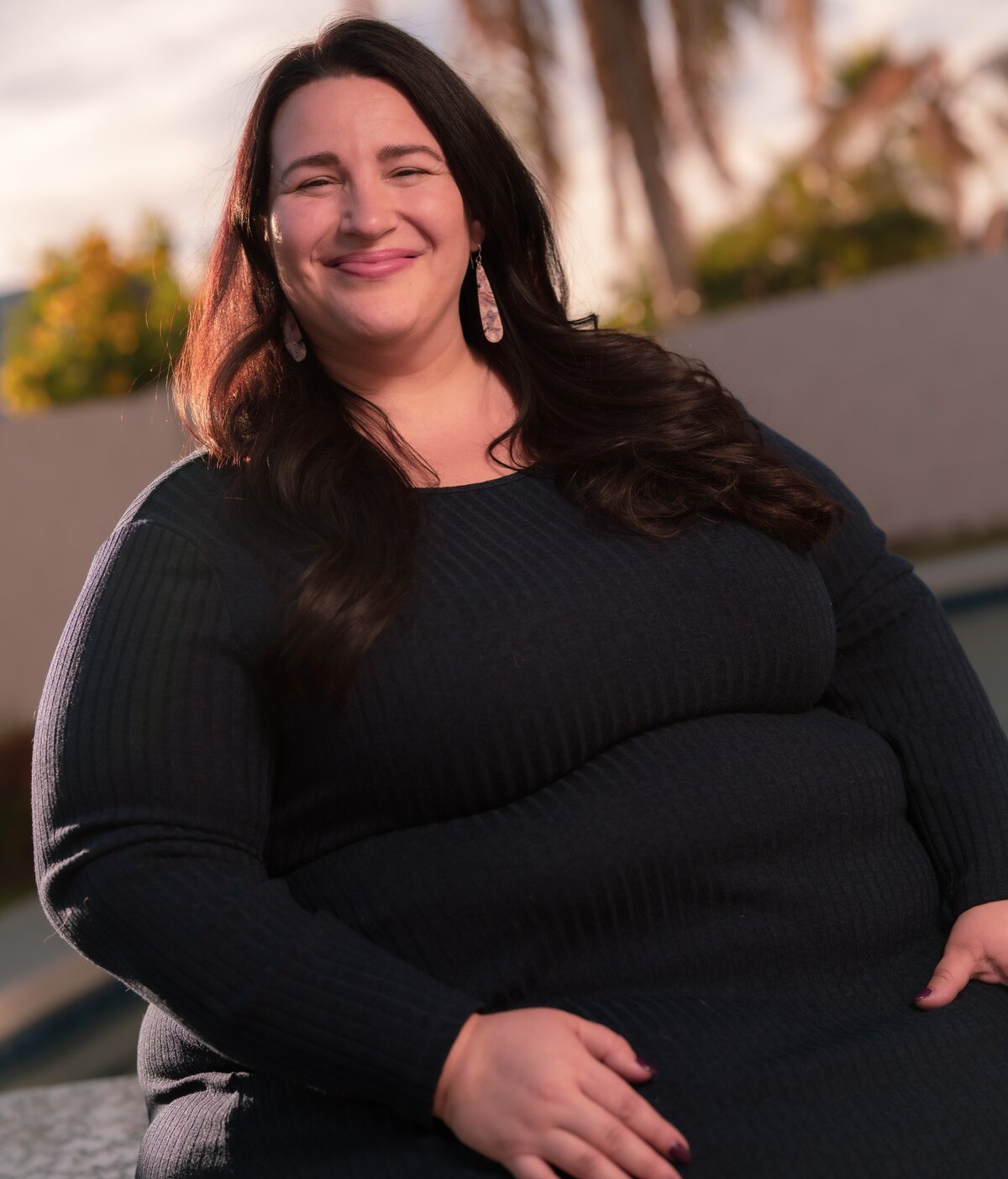 Anna Rodney sitting outdoors at golden hour