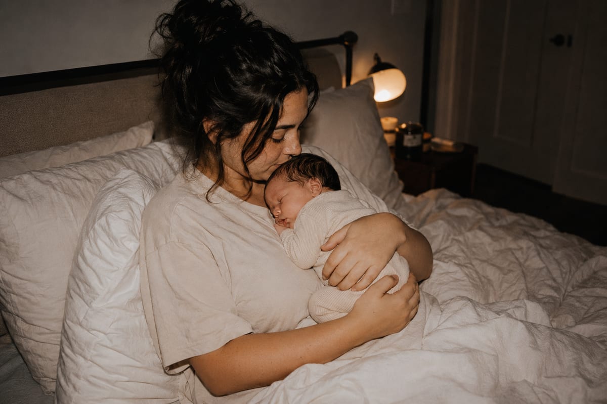 New mother holding her newborn postpartum