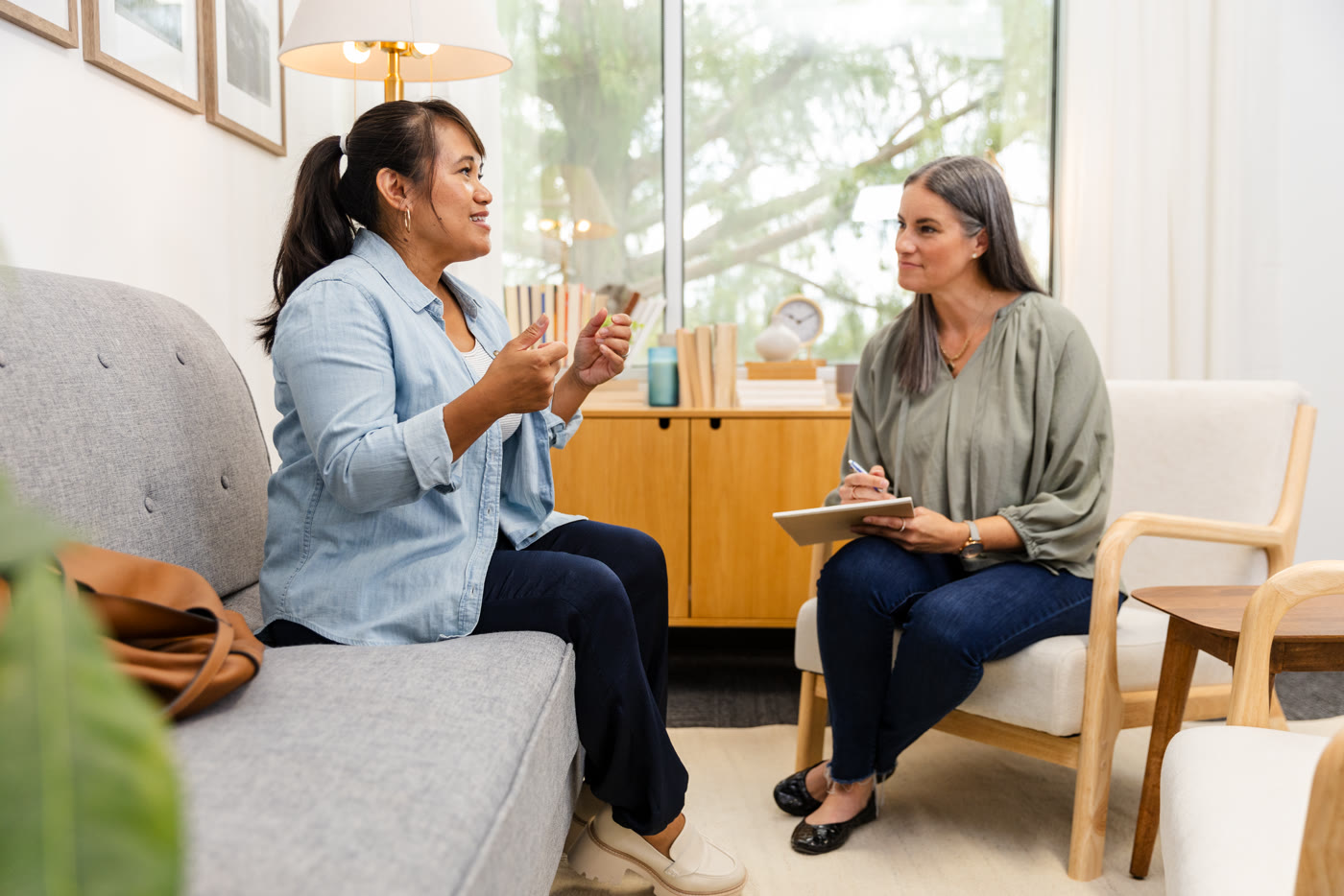Two professionals in conversation in a bright room